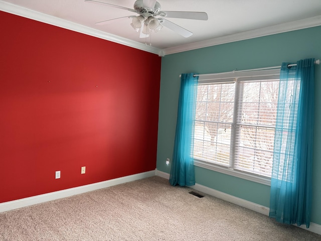 carpeted empty room with ceiling fan and crown molding