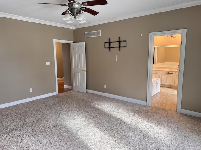 empty room with ceiling fan, light colored carpet, and ornamental molding