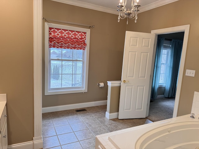 bathroom featuring vanity, ornamental molding, and a tub