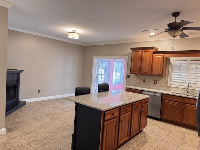 kitchen with a center island, crown molding, sink, stainless steel dishwasher, and tasteful backsplash