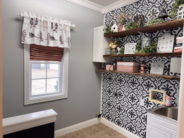 laundry room with light tile patterned floors and ornamental molding