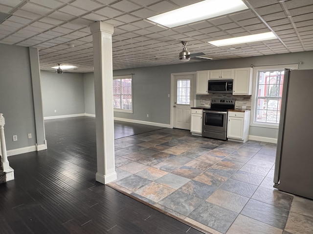 kitchen featuring stainless steel appliances, white cabinetry, tasteful backsplash, and plenty of natural light