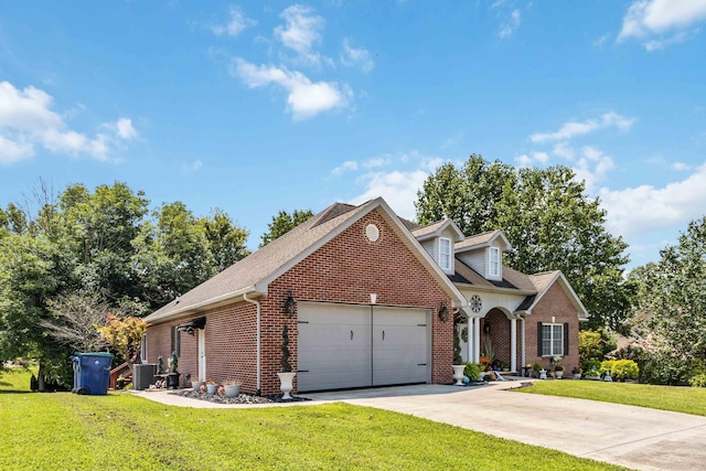 view of front of home featuring central AC, a front yard, and a garage