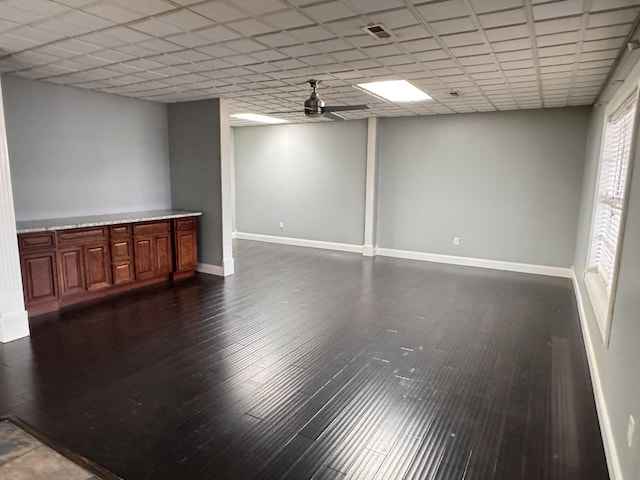 empty room featuring dark hardwood / wood-style flooring and ceiling fan