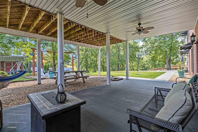 view of patio / terrace featuring a playground and ceiling fan