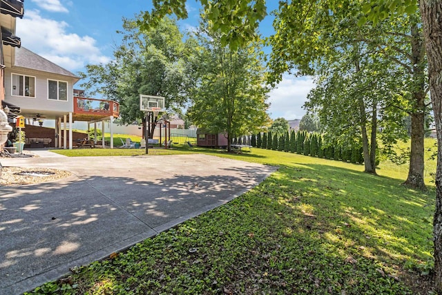 view of basketball court with a lawn