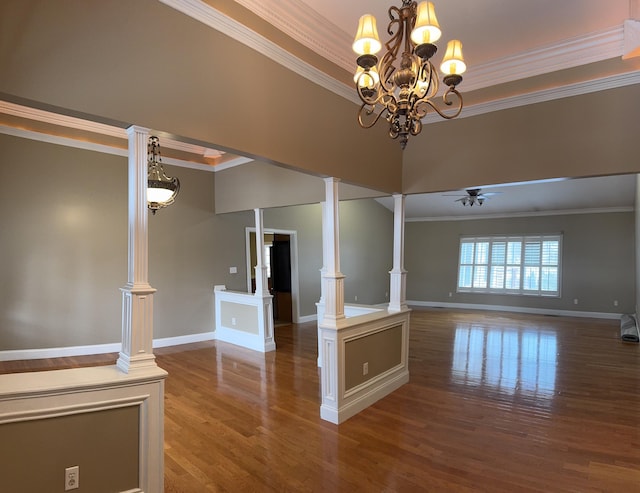 interior space featuring wood-type flooring, ceiling fan with notable chandelier, ornate columns, and ornamental molding