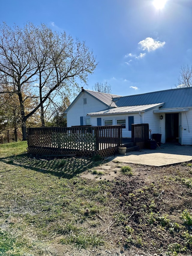 rear view of house featuring a patio area, a deck, and a yard