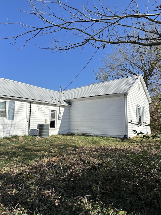 view of side of home with central air condition unit