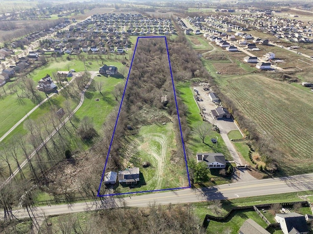 birds eye view of property with a rural view