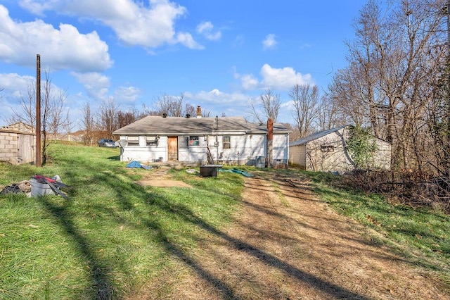 rear view of property with a lawn