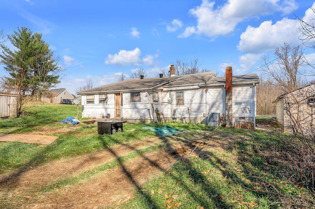 rear view of property with a yard