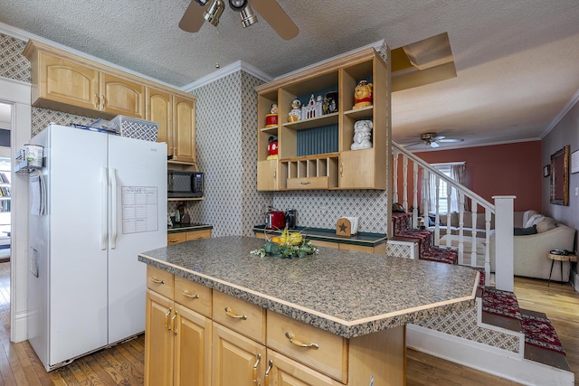 kitchen featuring a center island, light brown cabinets, white refrigerator, ornamental molding, and light hardwood / wood-style flooring