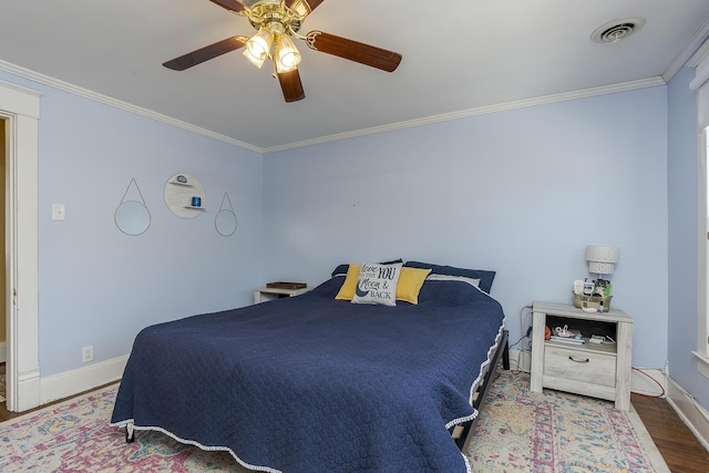 bedroom featuring ceiling fan, wood-type flooring, and crown molding