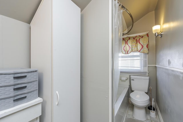 bathroom featuring tile patterned floors, toilet, and vaulted ceiling