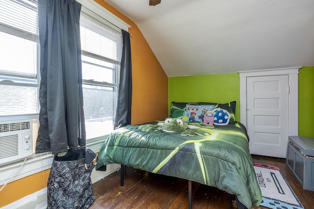 bedroom with ceiling fan, vaulted ceiling, and dark hardwood / wood-style floors