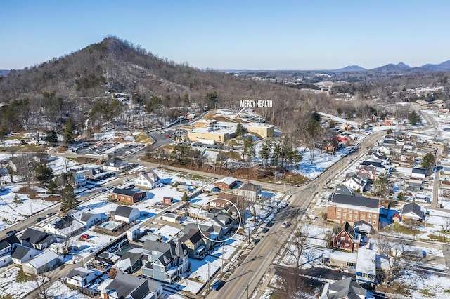 snowy aerial view with a mountain view