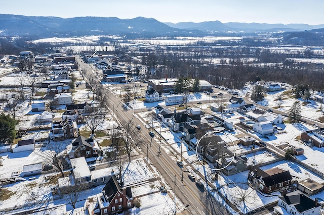 snowy aerial view featuring a mountain view