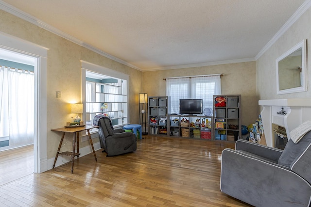 living room with a textured ceiling, crown molding, and hardwood / wood-style floors