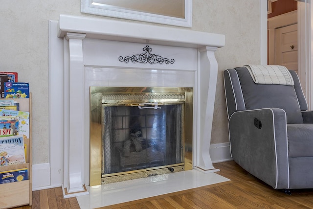 room details featuring hardwood / wood-style floors and a tile fireplace