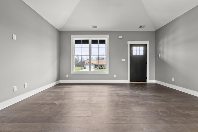 entrance foyer featuring dark hardwood / wood-style floors and lofted ceiling