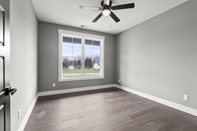 empty room with ceiling fan and light hardwood / wood-style flooring