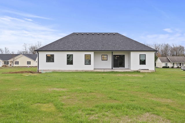 rear view of house with a yard