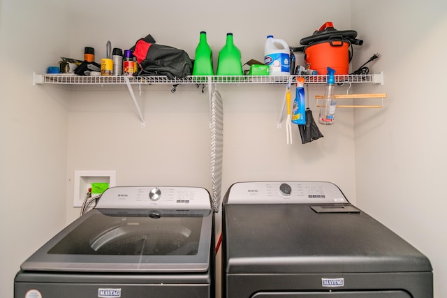 clothes washing area featuring washing machine and clothes dryer