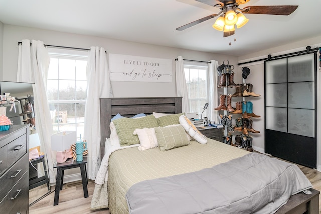 bedroom with ceiling fan and light wood-type flooring