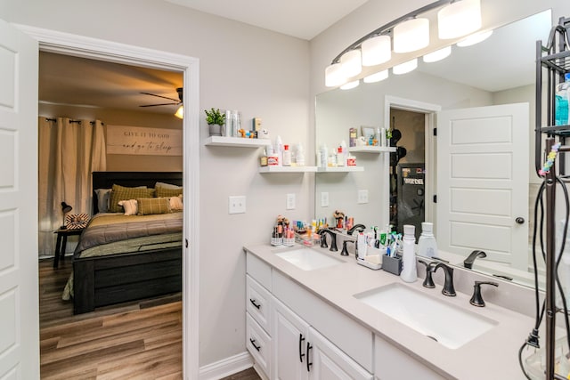 bathroom with ceiling fan, hardwood / wood-style floors, and vanity