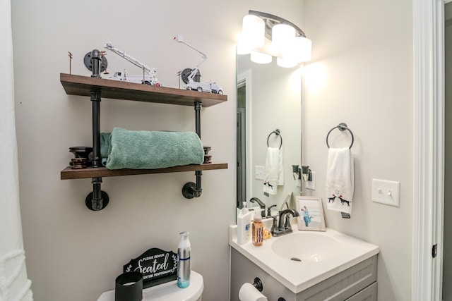 bathroom with toilet and vanity