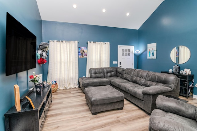 living room with light hardwood / wood-style floors and lofted ceiling