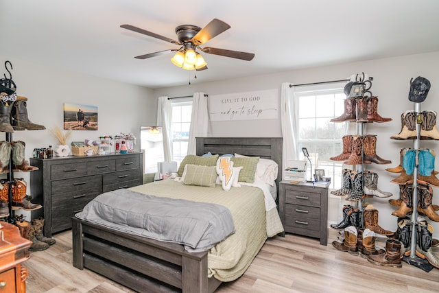 bedroom with ceiling fan and light hardwood / wood-style floors