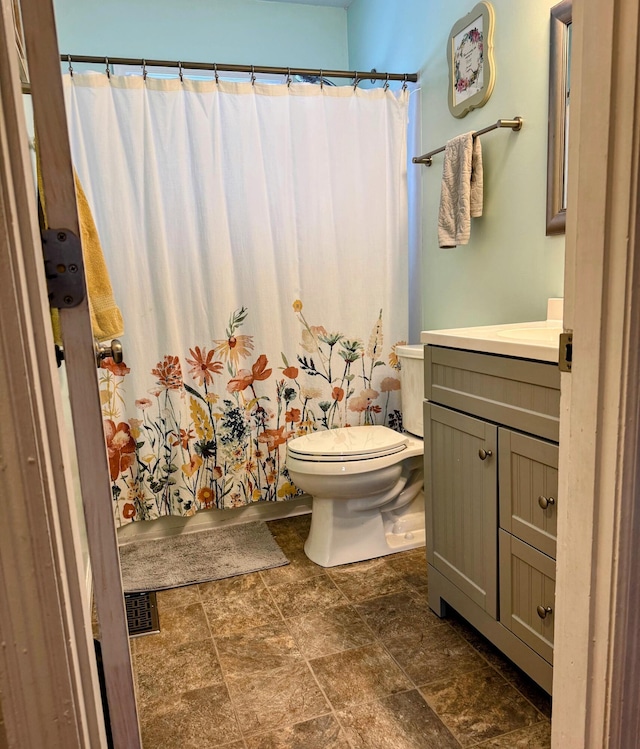 bathroom featuring vanity and toilet