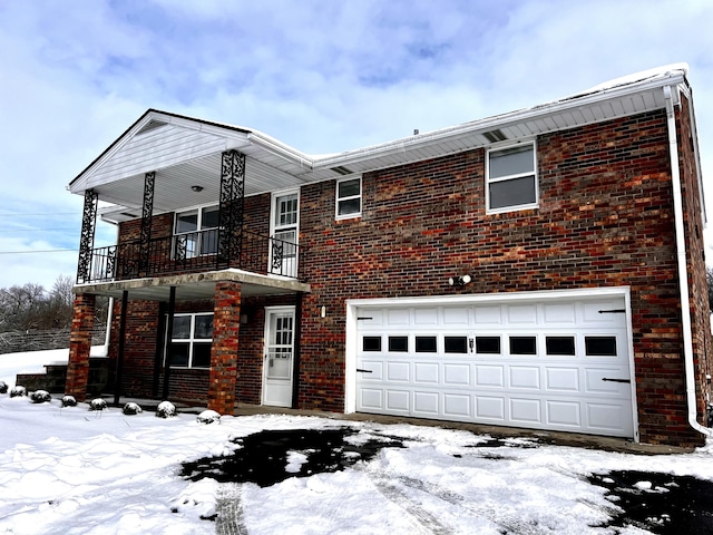 view of front facade featuring a balcony and a garage