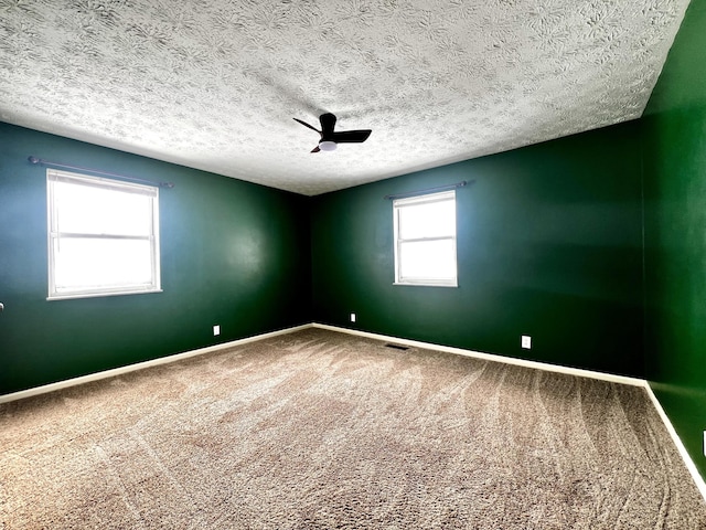 carpeted spare room featuring a textured ceiling