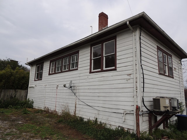 view of side of home with central AC