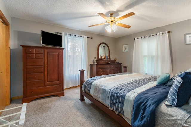 bedroom with light carpet, a textured ceiling, and ceiling fan