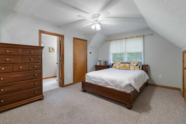 carpeted bedroom with lofted ceiling, ceiling fan, and a textured ceiling