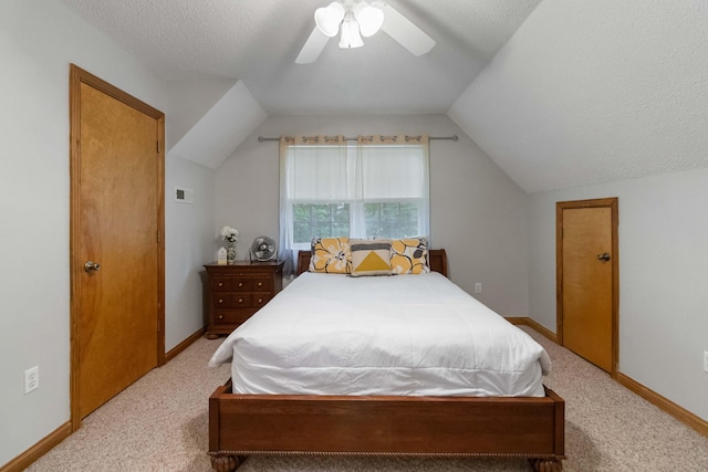 bedroom featuring a textured ceiling, light colored carpet, ceiling fan, and lofted ceiling