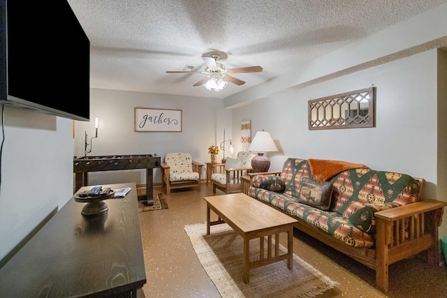 living room with ceiling fan and a textured ceiling