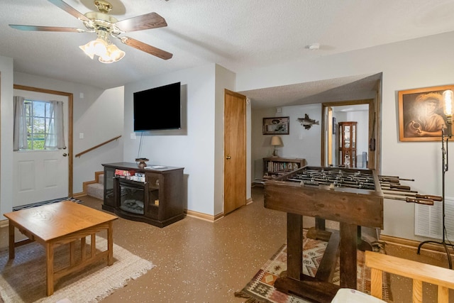 game room featuring a textured ceiling and ceiling fan