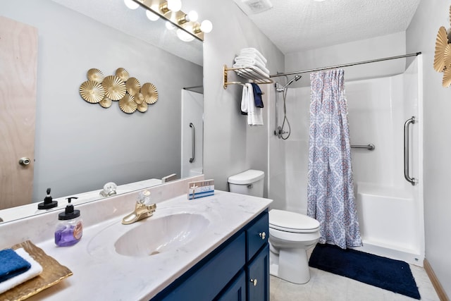 bathroom with vanity, a textured ceiling, toilet, and walk in shower