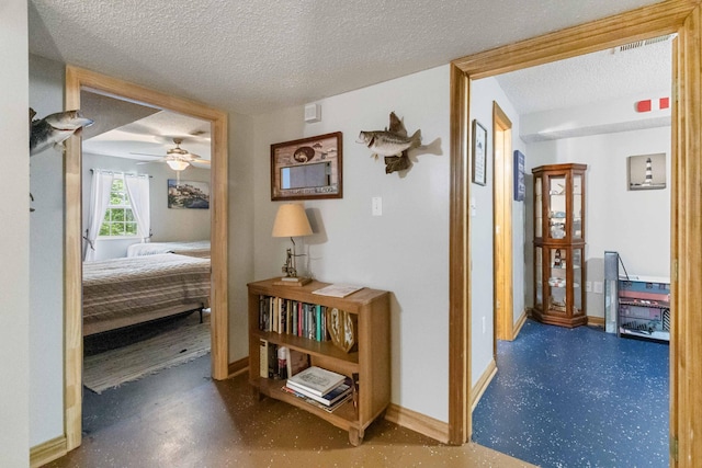 hallway featuring a textured ceiling