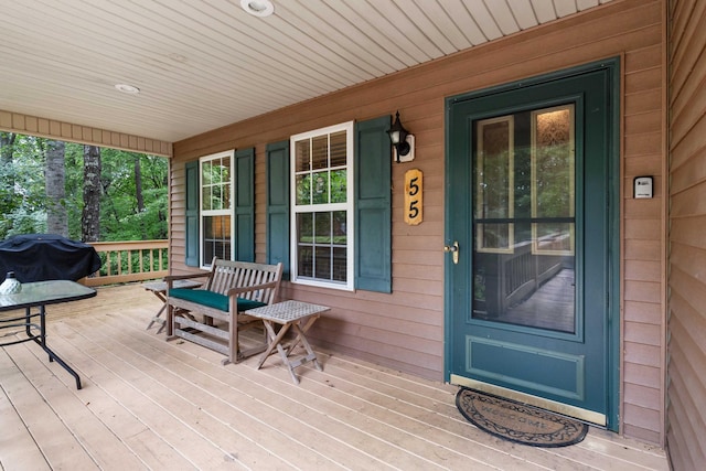 view of exterior entry featuring a porch