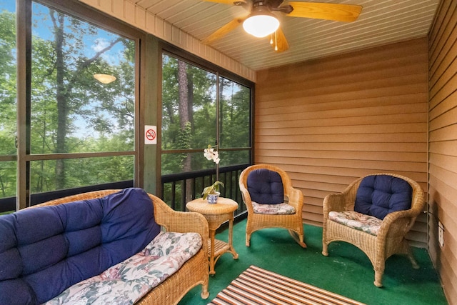 sunroom featuring ceiling fan