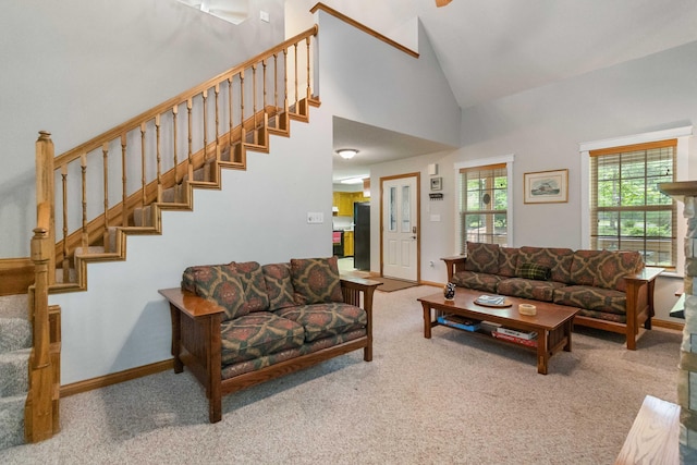 carpeted living room featuring high vaulted ceiling