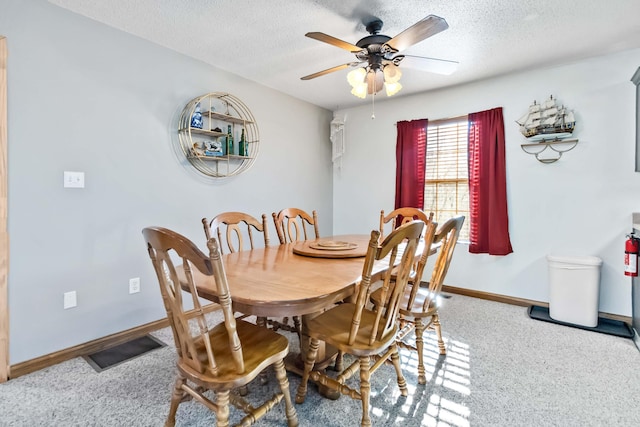 dining space with ceiling fan and a textured ceiling