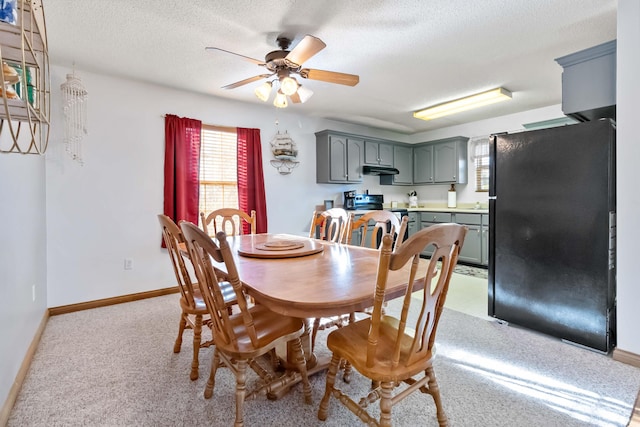 dining room featuring ceiling fan and a textured ceiling