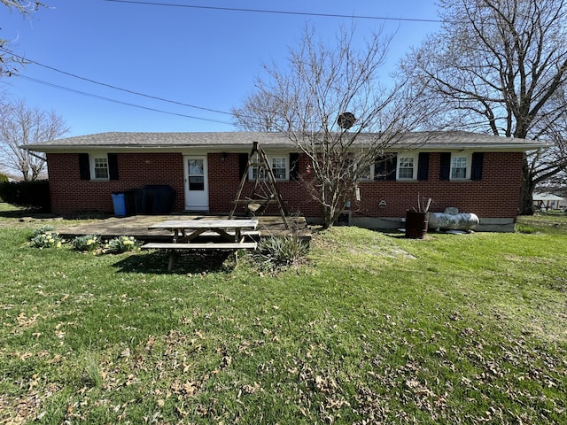 rear view of property with a yard